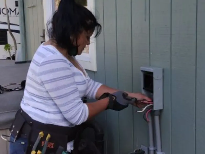 Licensed electrician wiring an exterior subpanel in Cornwall